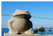 海ぞいに置かれた、石のカエルの像